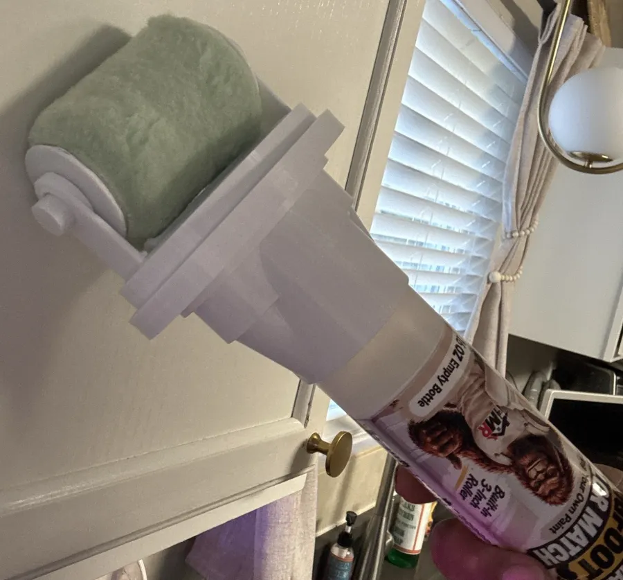 Mr. Brushable BIGFOOT bottle with built-in 3-inch roller held against a cabinet
