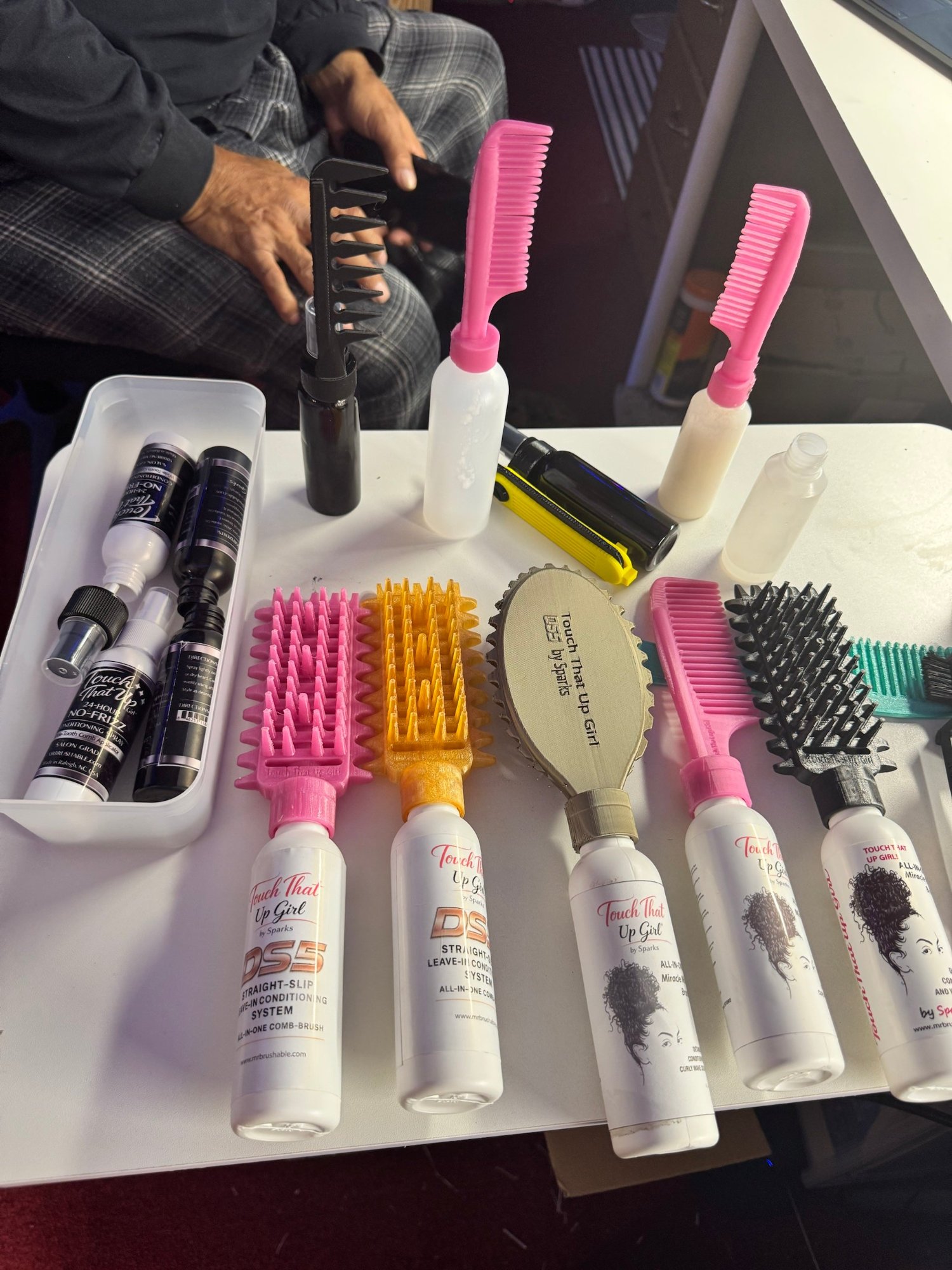3D-printed applicator brushes and bottle prototypes on David Sparks’ workbench